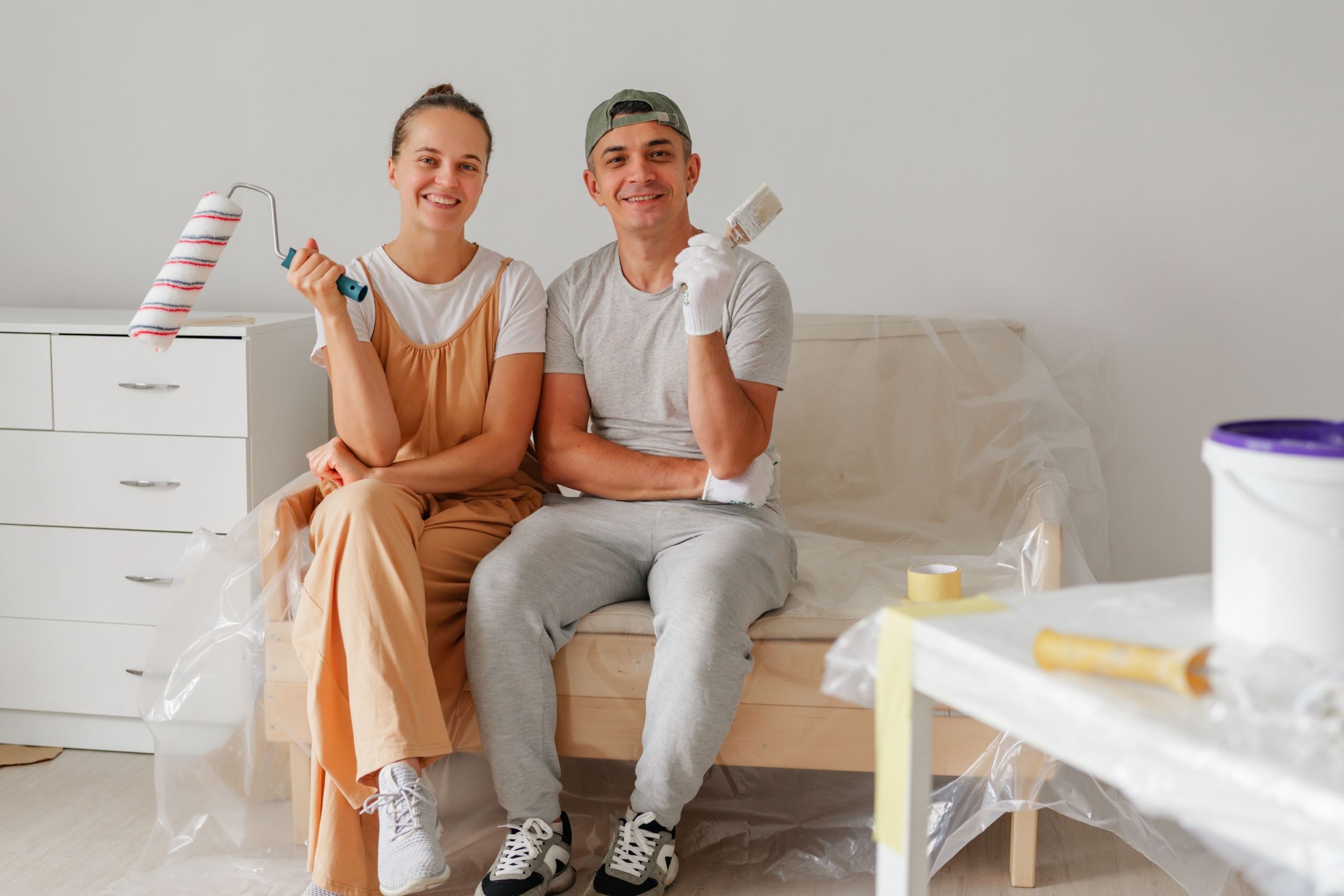 A couple painting the inside of a house